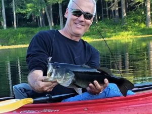 Pete Schoenberger shows off a bass he caught in Fitzgerald Lake.